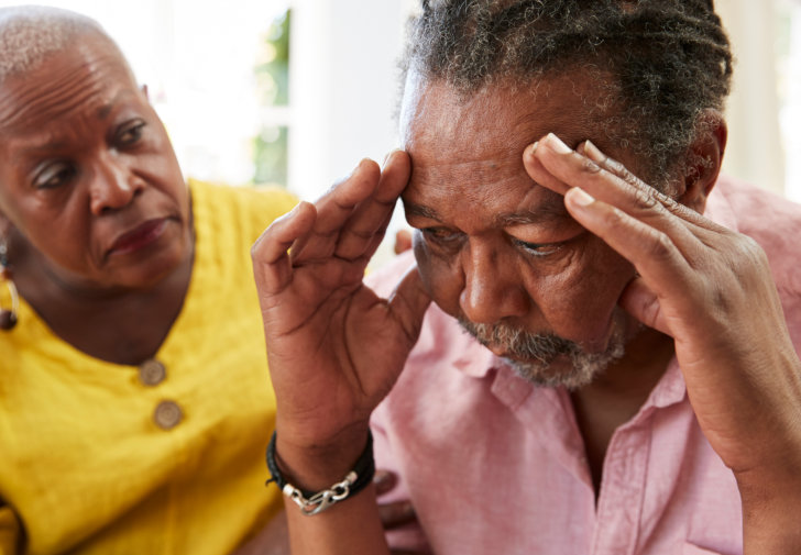 Woman Comforting Man With Depression At Home